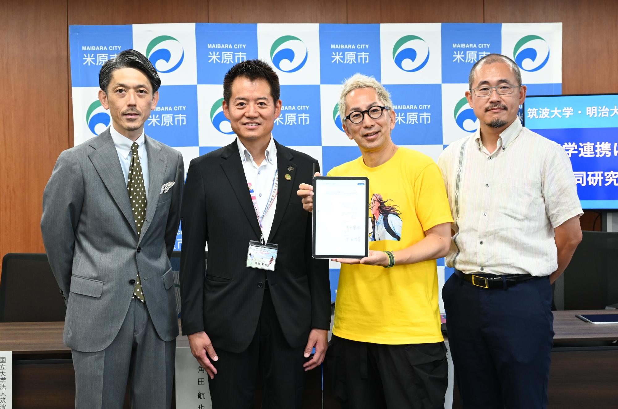 角田市長と、電子契約書の署名(タブレット)をもつ株式会社ワコム社長、筑波大学山田教授、明治大学中村教授の記念写真