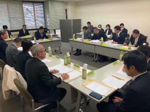 会議室にて、長机で囲んで会議している様子。